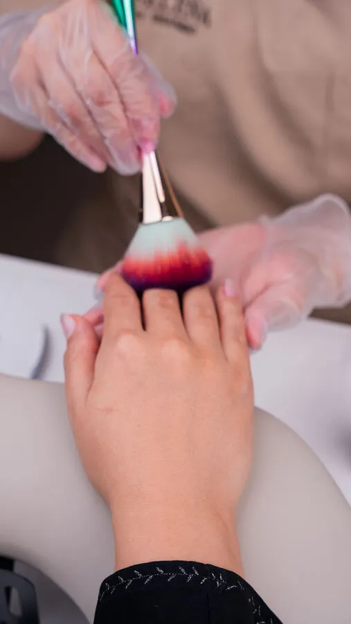Dusting nails after shaping at Nova Selena Spa